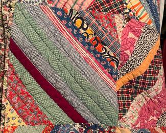 There is a nice collection of hand stitched quilts including this one