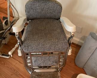 Antique barber chair with razor strop.