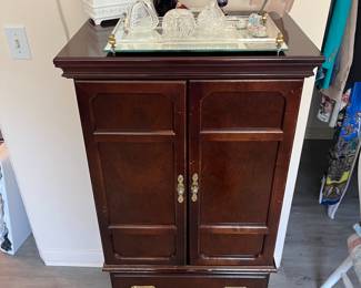 Victorian jewelry cabinet with doors closed.