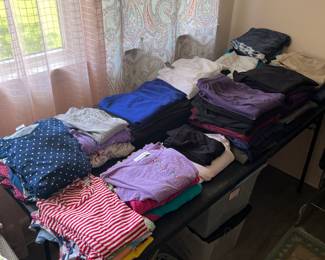 More women’s, small, medium and large blouses, sweaters, and pants.