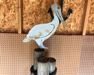 Vintage metal pelican on a post.