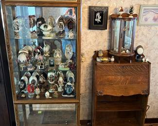 Large curio cabinet with decorative eggs, small table, top curio cabinet, and Secretary.
