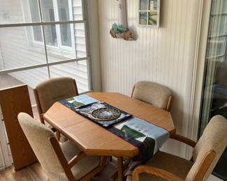 Table with four chairs and one leaf.