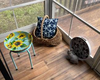 Vintage basket, plant stand, and throw pillow.