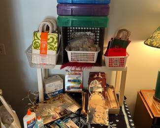 Craft supplies, decorative gift bags, and storage boxes.