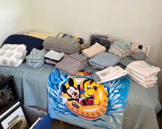 Brand new twin bed, linens, and Mickey Mouse beach towel.