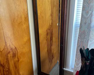 Wall mounted jewelry cabinet with door closed.