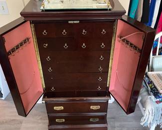Victorian jewelry cabinet with doors open.