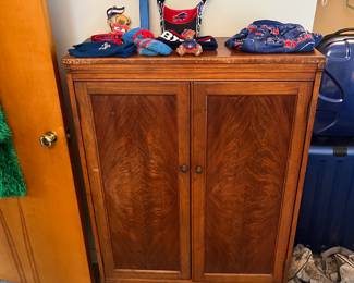 Walnut hutch With Buffalo Bills memorabilia on top.