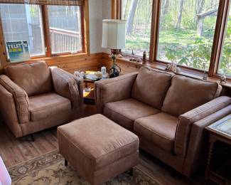 Matching suede couch, chair and ottoman.