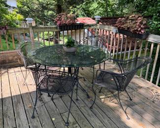 Metal patio furniture- large round table and 4 matching metal chairs with nice design. Sturdy and weather resistant. Also shown is round glass table top.