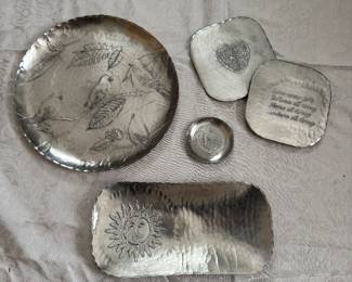 Well-known aluminum craftsman leaf designed plate, rectangle dish with sun, saucer, and two coasters. A sample of the large collection of hand-crafted aluminum pieces available.