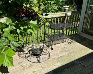 Vintage metal patio recliner chair and a vintage metal buffet cart with two shelves on wheels.