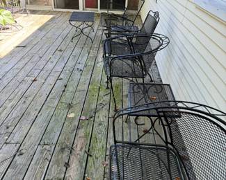 Vintage-style metal patio furniture. Collection of chairs and small tables and a large round table in various styles and designs. Sturdy and weather resistant.