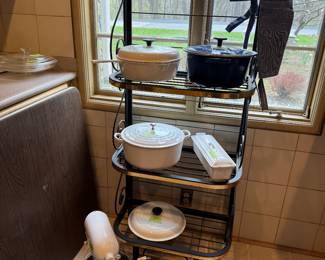 Collection of casserole dishes featuring Le Creuset, which are known for quality and versatility in cooking and can go from freezer to oven to table. Also pictured is a KitchenAid freestanding mixer in white.