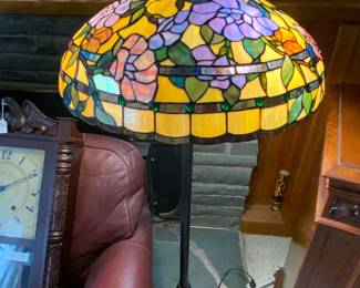 Quoizel floor lamp; yellow with colored flowers and black base with design.