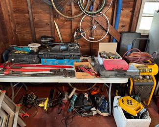 Collection of hand and power tools: wrenches and other hand tools and a collection of power tools and tool sets.