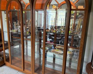 Oval top wood and glass curio display cabinets with glass shelves, back mirrors and lights in beautiful condition.