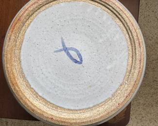 Vintage pottery decorative plate with blue fish design and colored border