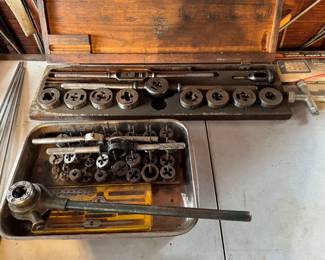 Vintage tap and die set used for creating screw threads. Various taps and dies of different sizes and die guides.