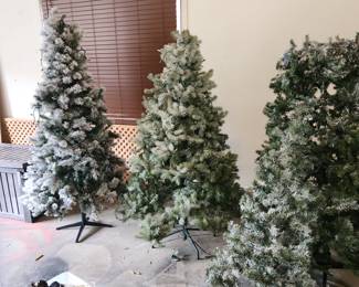 3 lighted fake Christmas trees
