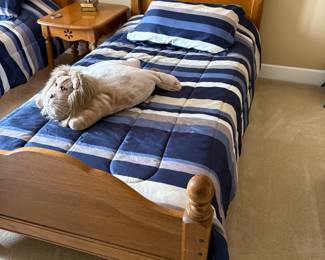 . . . one of two matching oak twin beds