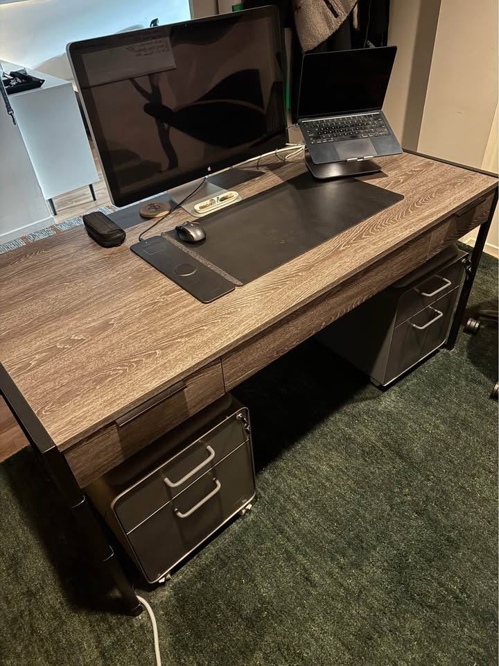 Only 1 year old - Large, modern writing desk - Sleek shape and timeless look - Black iron base - Keyboard tray - 3 Drawers with soft-close - Finished back - Functional and good looking - Solid Hardwood, Brown - Fits multiple monitors
- No flaws or scuffs, in perfect condition
Measurements = 30” tall 62” wide 30” deep - $450 + tax.