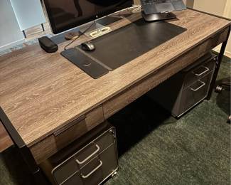 Only 1 year old - Large, modern writing desk - Sleek shape and timeless look - Black iron base - Keyboard tray - 3 Drawers with soft-close - Finished back - Functional and good looking - Solid Hardwood, Brown - Fits multiple monitors
- No flaws or scuffs, in perfect condition
Measurements = 30” tall 62” wide 30” deep - $450 + tax.