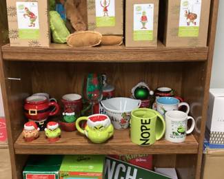 CABINET FULL OF DR. SEUSS CHRISTMAS GRINCH COLLECTIBLES, PLACE MATS, CLOTHING, JIM SHORE ORNAMENTS, GLASSWARE, FIGURINES, PLATES
