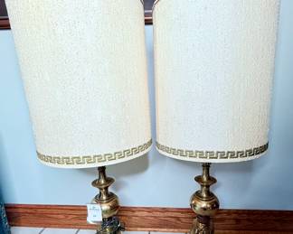 Pair of Mid-Century brass table lamps in excellent condition. The lamps are each 40 1/2 inches tall.