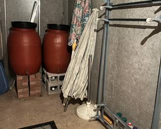 unused rain barrels , outdoor umbrellas, full side frame