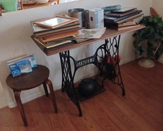Picture frames and antique sewing table.