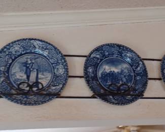 Collectible blue and white plates with metal holder.