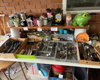 Table full of kitchenware & utensils