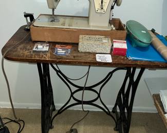 Singer model 237 sewing machine and an antique iron base table.