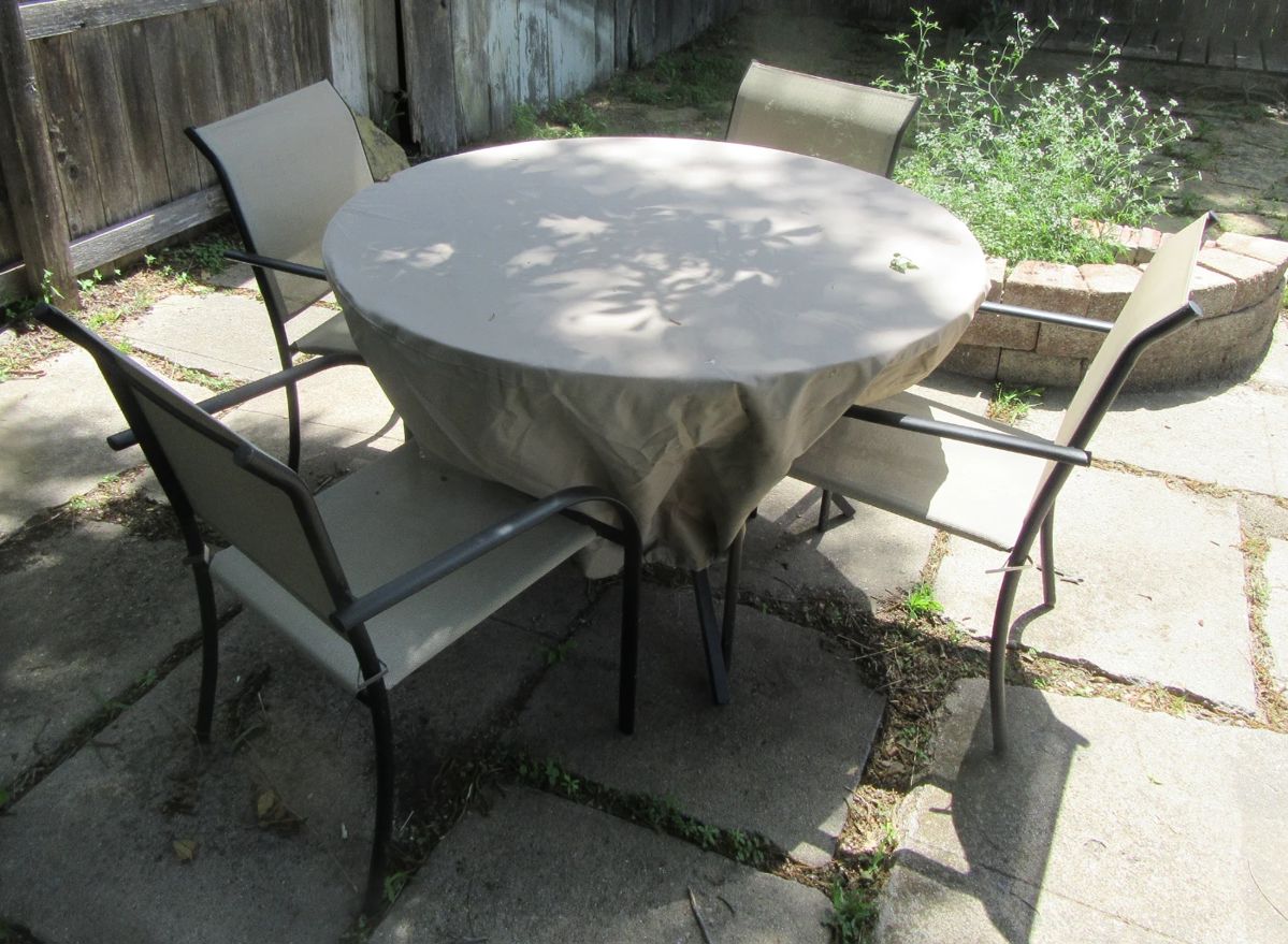 Very nice outdoor patio set, glass top table (has been covered for protection.) Included are 4 matching chairs. Located backyard new garage.