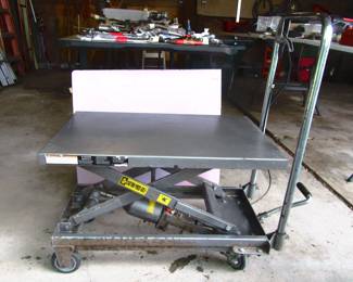 Scissor jack lift table works great. Located in garage.
