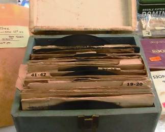 Vintage 45 rpm record box containing 70 45 rpm records.
