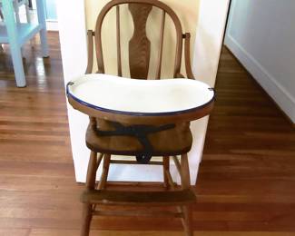 Baby highchair with rare porcelain tray. Stands about four foot tall. Located in living room of house.