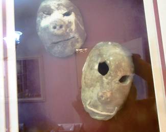 Framed some type of clay or mortar mask? Framed in expensive shadow box frame.