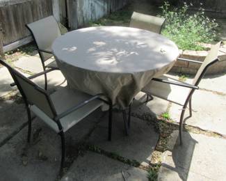 Very nice outdoor patio set, glass top table (has been covered for protection.) Included are 4 matching chairs. Located backyard new garage.