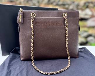 Classic and timeless. Chanel brown leather shoulder bag featuring a gold-tone chain-link shoulder strap interwoven with leather, embossed “CHANEL” logo on the front, and zip-top closure with signature logo zipper pull. Crafted from rich, durable leather with elegant structure.
Includes original Chanel dust bag and box.
Authentication verified.