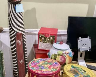 Cat sculpture, tins, television 