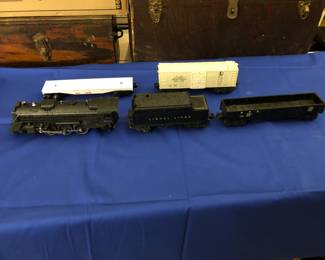 1950's smoking locomotive with tender and other cars. Controller and track available