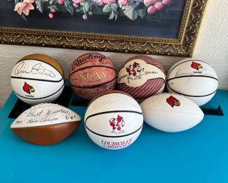 Various University of Louisville signed footballs and basketballs Denny Crum