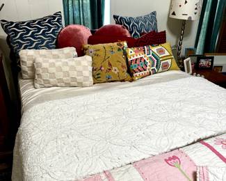 Underneath this cozy grouping of quilts, throws, and comfy pillows is a Queen sized bed with headboard and footboard that includes a mattress and box springs, if you want.