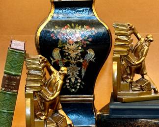 Black and gold Tole hand painted urn with lid.
Art Deco librarians stacking falling books book ends.