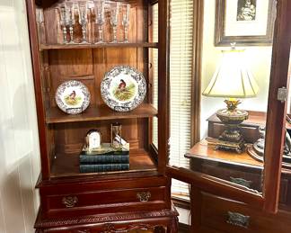 Chippendale style display cabinet on ball and claw feet in a warm Cherry finish.