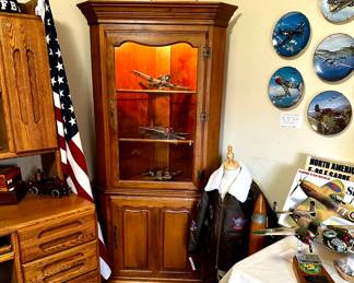Maple corner cabinet. Glass front lighted display cabinet top over two tiered storage.