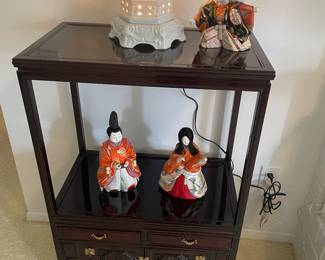 Asian console cabinet, dolls and lamp